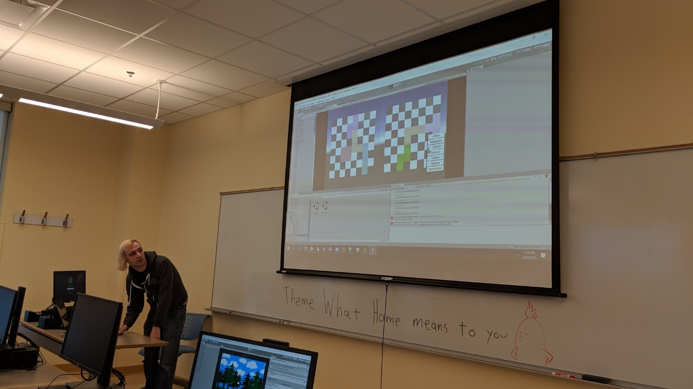 a young man with pastel colored hair standing in front of a board with a game projected onto the screen above his head.